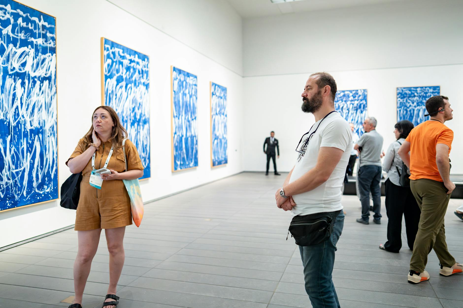 Visitors viewing paintings in a Berlin art gallery