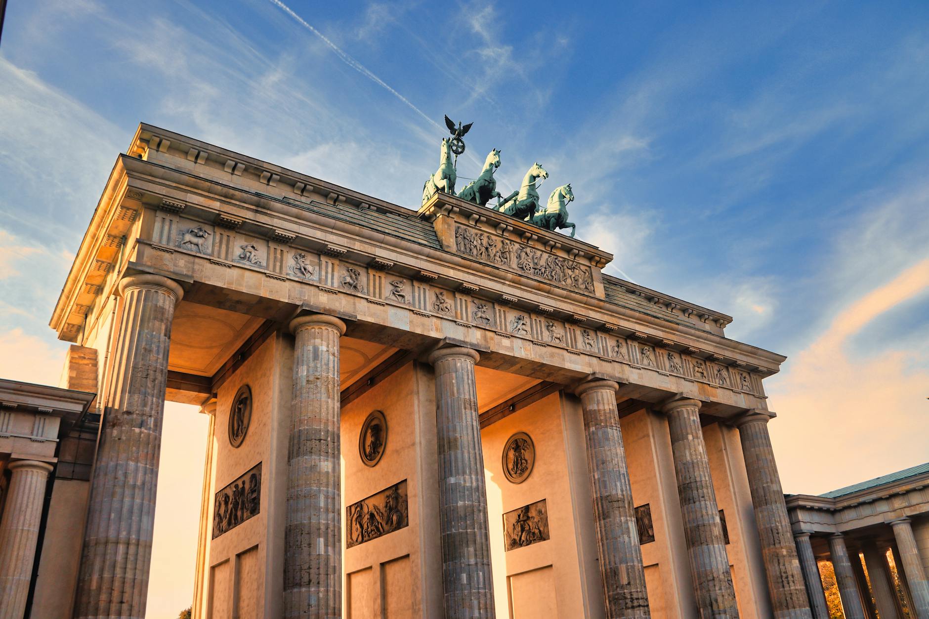 Brandenburg Gate illuminated at sunset in Berlin