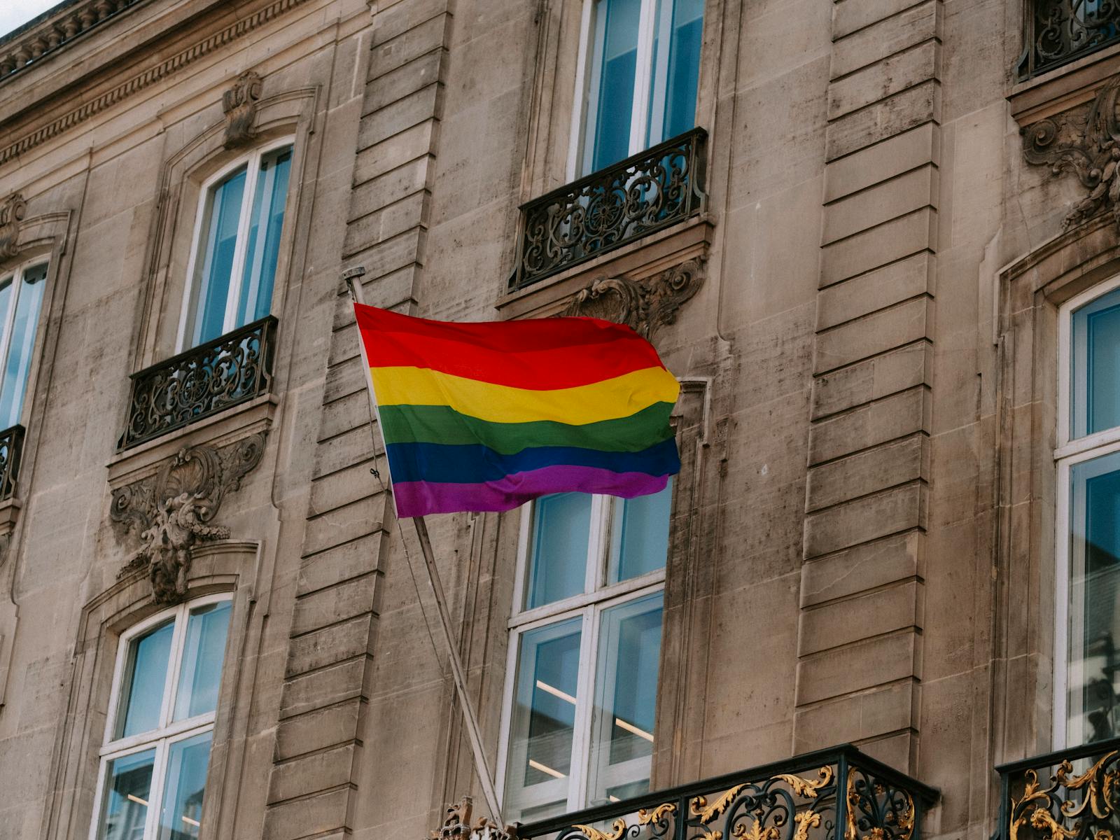 LGBTQ pride flag in front of historic Berlin building