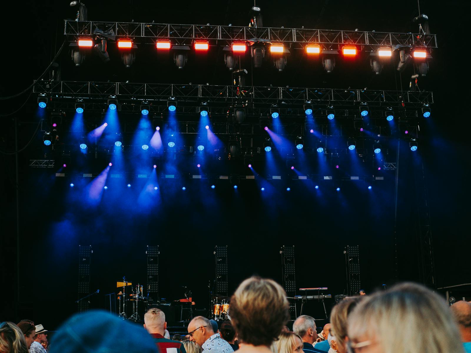 Concert stage with audience and colourful lighting