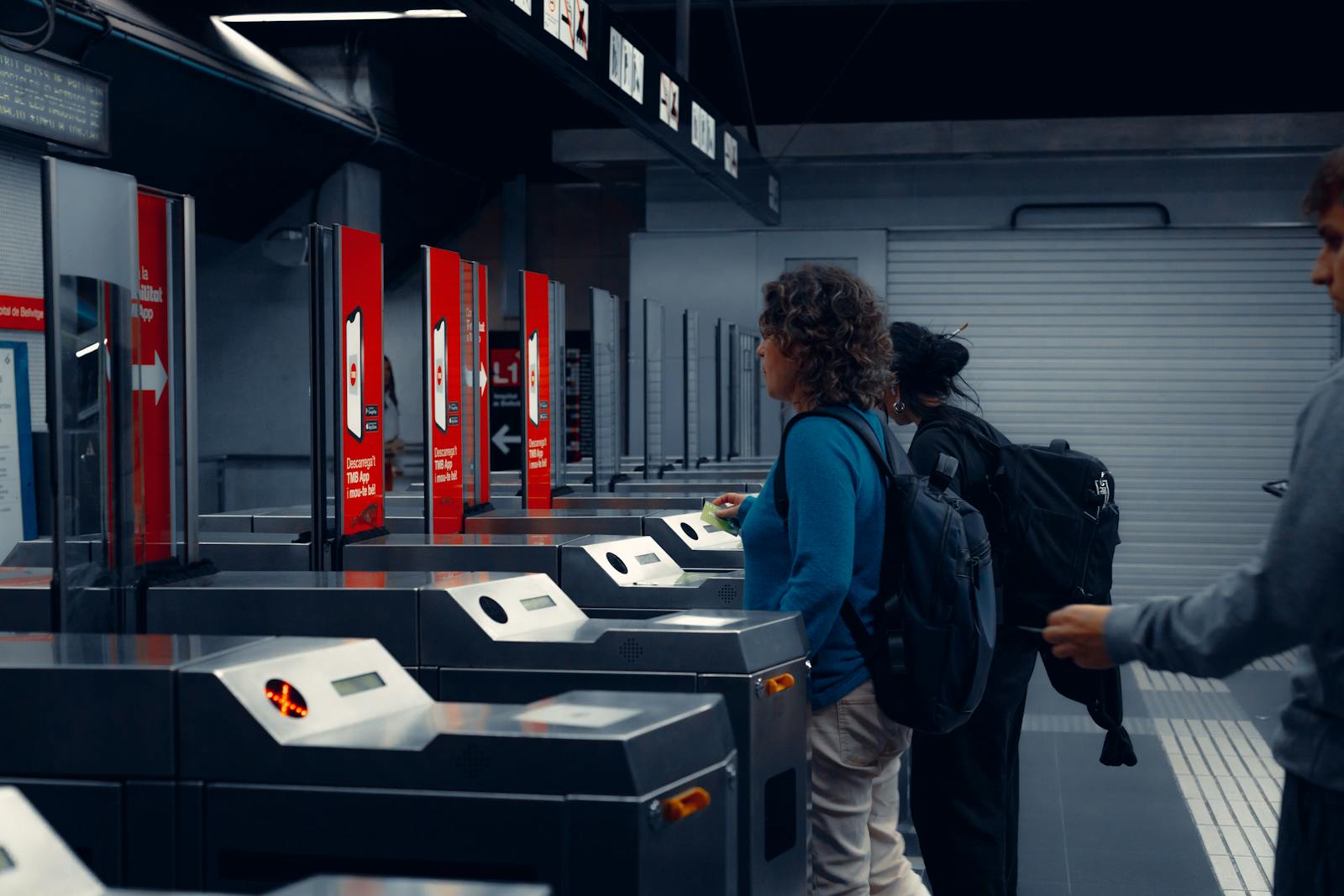 Commuters using turnstiles at a modern Berlin subway station