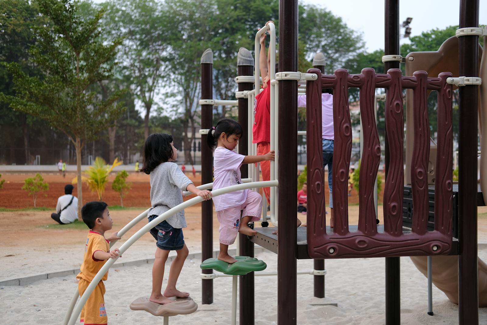 Children climbing at an outdoor playground