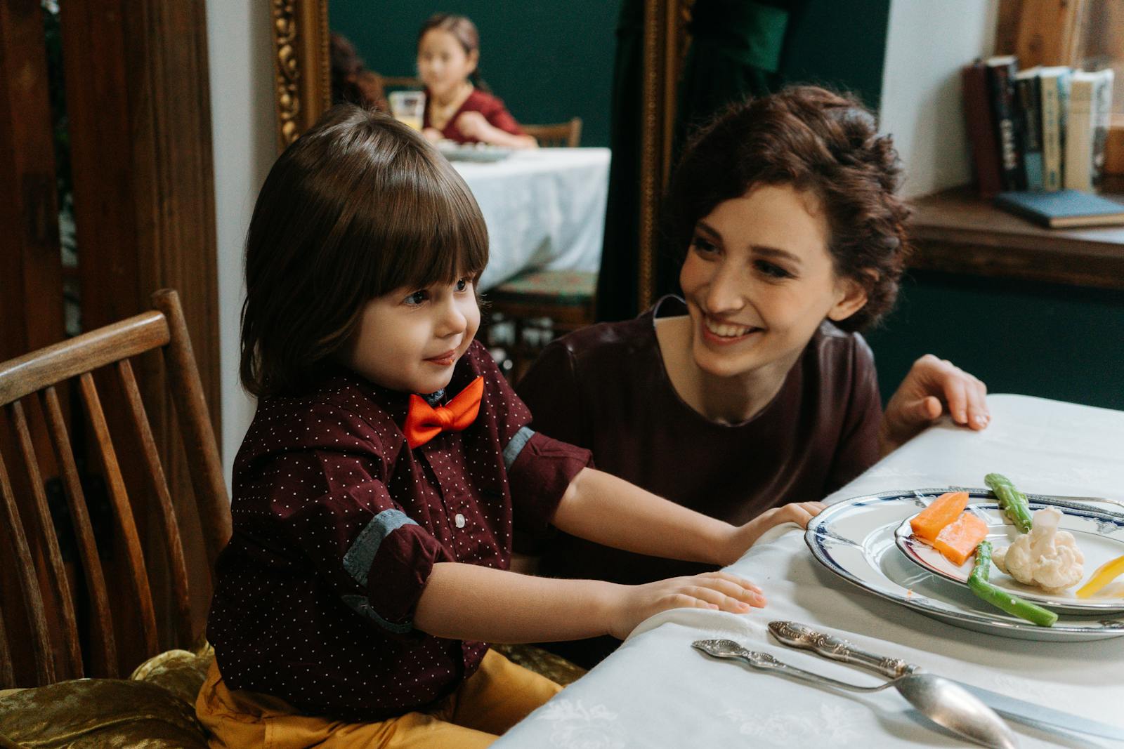 Mother and son smiling during a meal