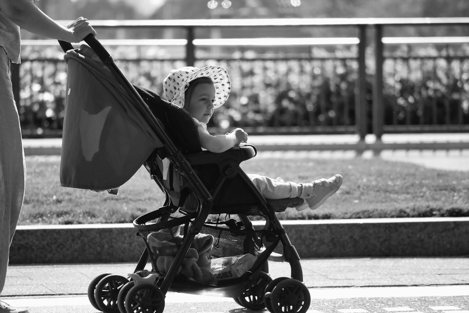 Baby in sun hat in a stroller