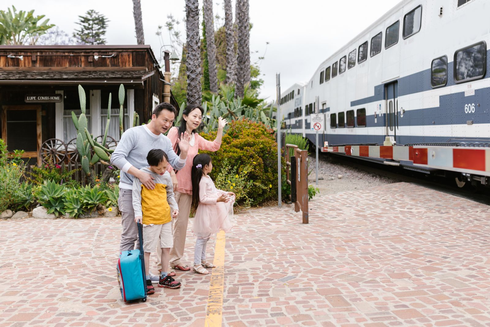 Family waving as a train departs
