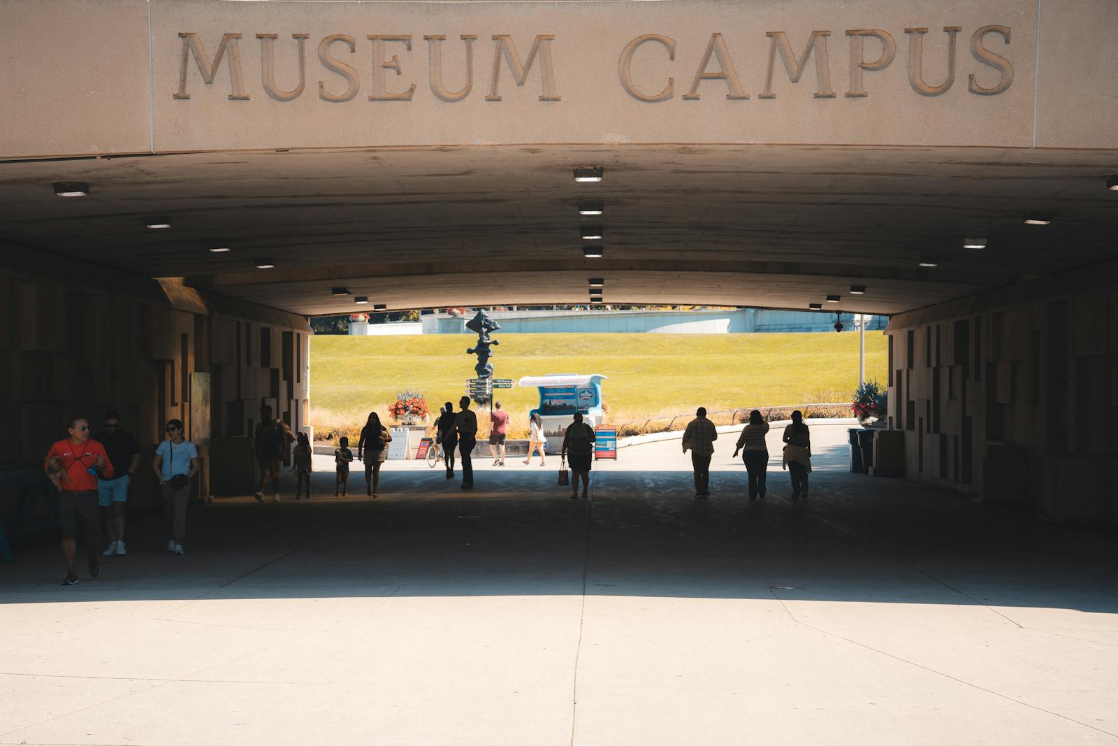Silhouette of visitors walking through a museum tunnel