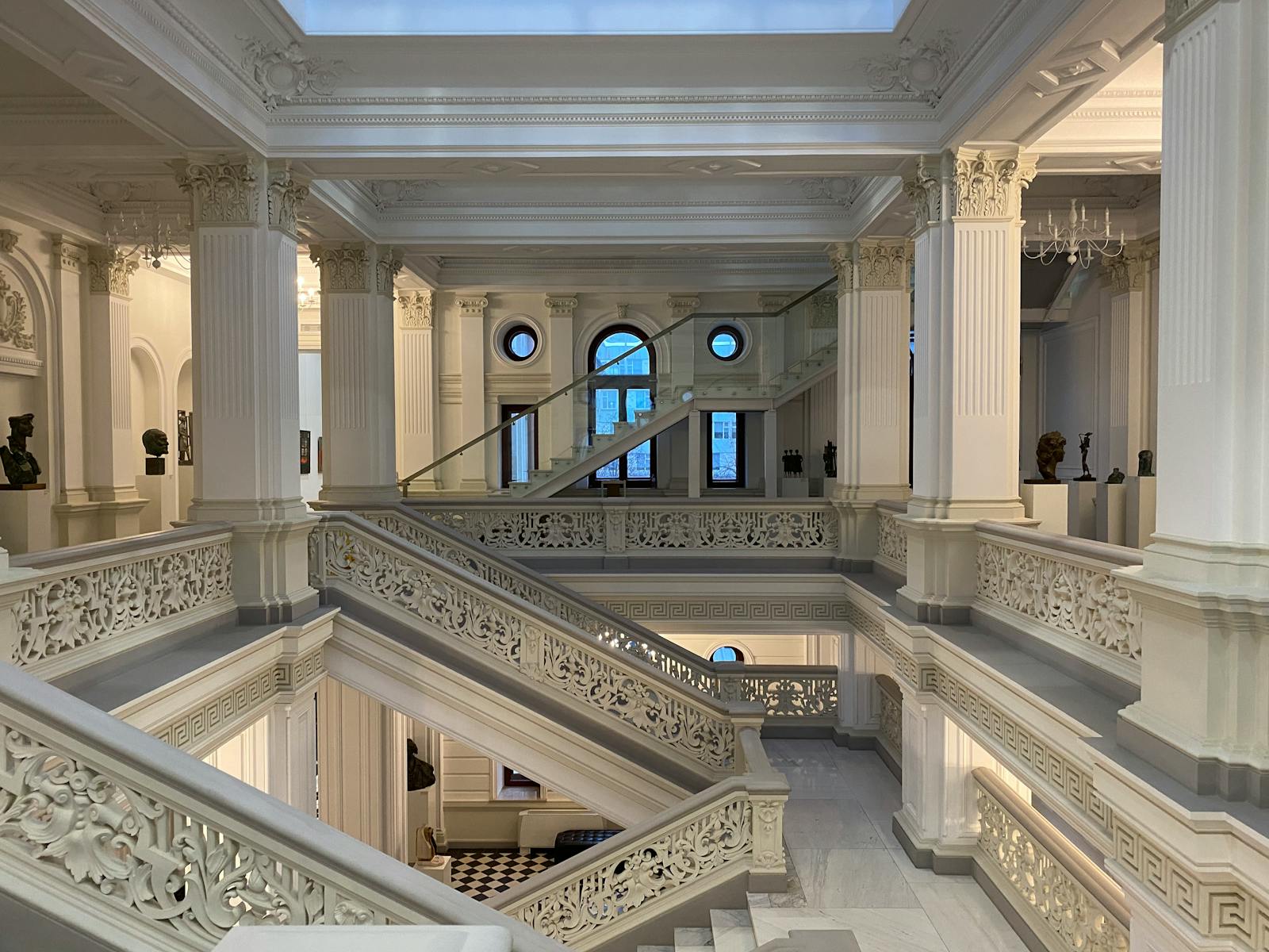 Luxurious museum stairway with ornate columns