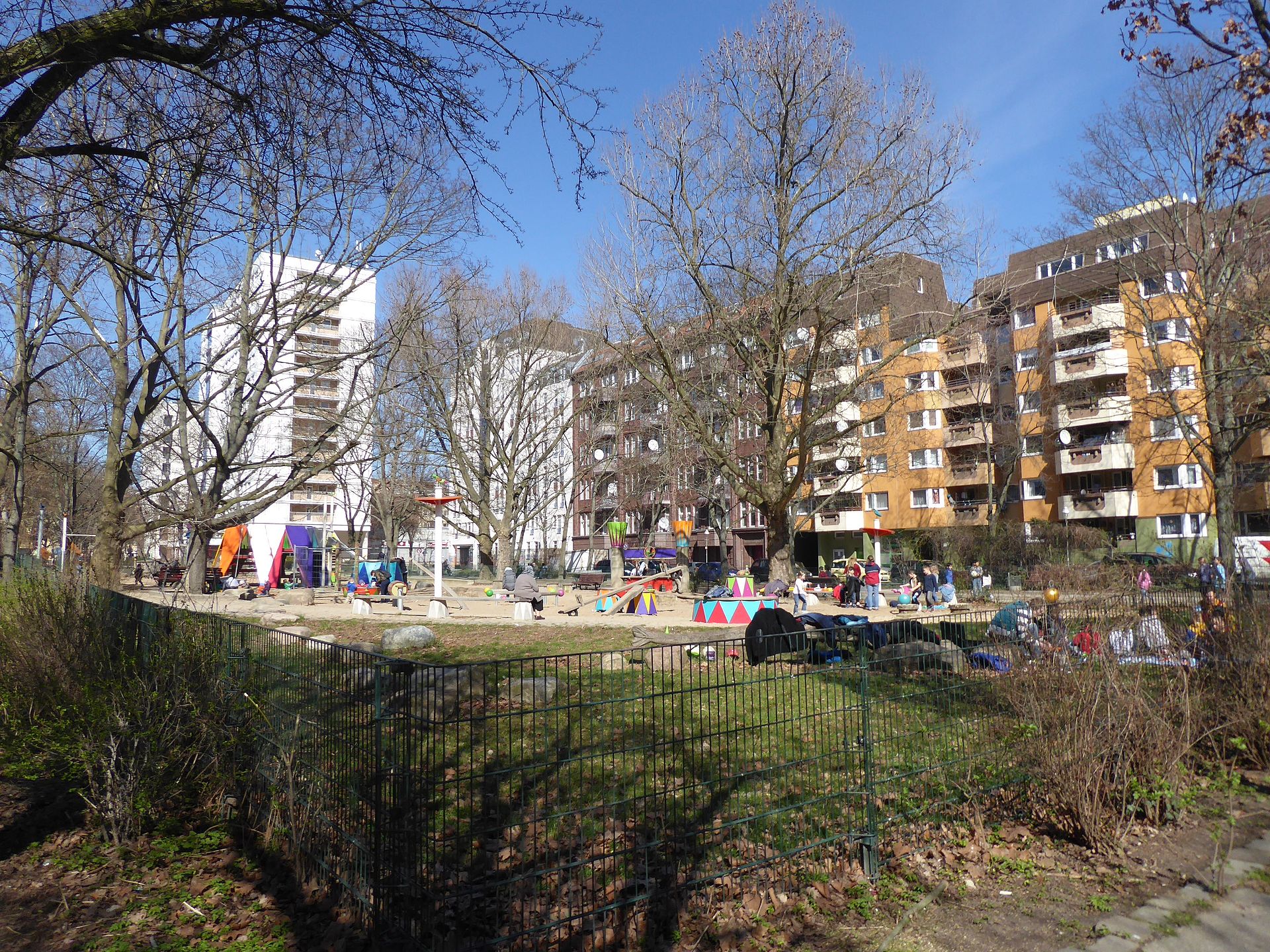 A busy playground surrounded by 1970s apartment blocks in the Wedding district of Berlin