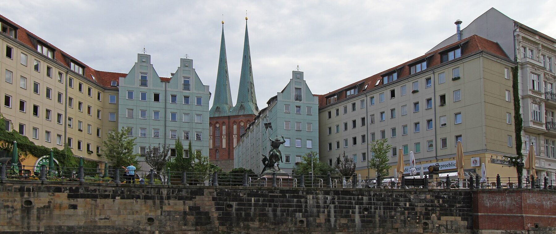 The Nikolaiviertel seen from the Spree with the twin spires of the Nikolaikirche behind the riverside buildings