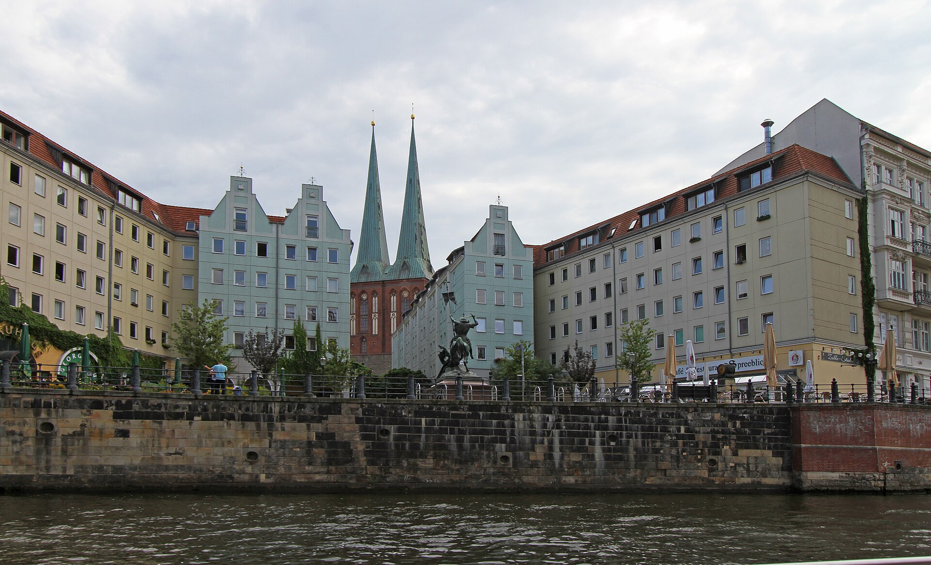 The Nikolaiviertel seen from the Spree with the twin spires of the Nikolaikirche behind the riverside buildings
